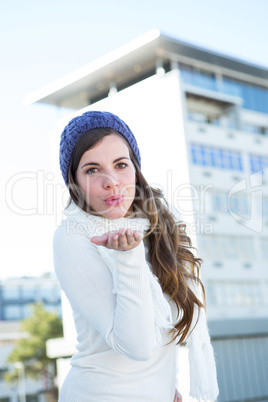 Attractive brunette blowing kiss