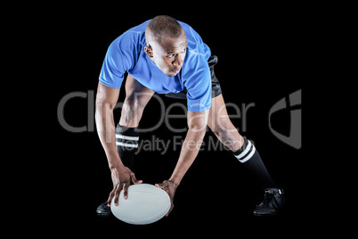Rugby player holding ball while playing