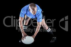 Rugby player holding ball while playing
