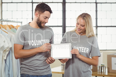 Colleagues holding digital tablet in office