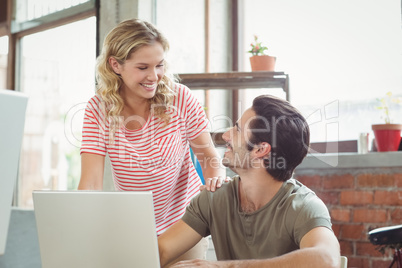 Happy business people discussing in office