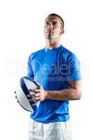 Sports player looking away while holding ball