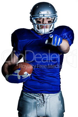 Portrait of American football player in uniform pointing