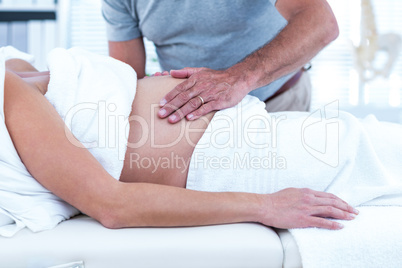 Masseur giving massage to pregnant woman