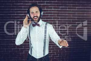 Hipster with eyes closed enjoying listening music