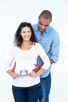 Happy woman with ultrasound scan and husband against white backg