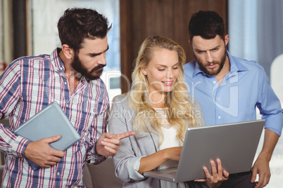 Man pointing towards laptop