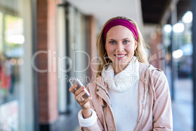 Smiling woman holding smartphone