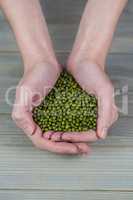 Woman showing handful of lentils