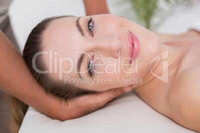 Smiling woman receiving neck massage