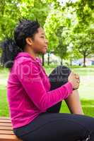 Fit woman sitting on bench