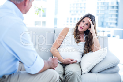Depressed preganant woman talking with therapist