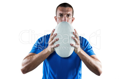 Portrait of rugby player in blue jersey holding ball