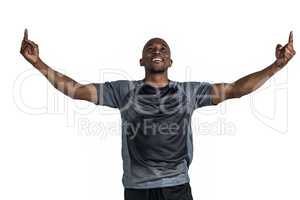 Happy sportsman with arms raised after victory