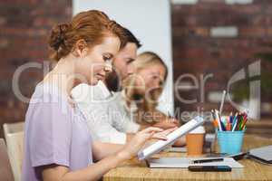 Businesswoman using digital tablet in office