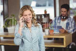 Businesswoman talking over phone in office