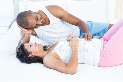 Happy husband touching pregnant wife belly