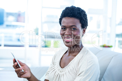 Portrait of happy woman holding cellphone