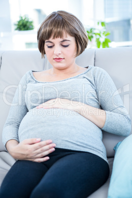 Pregnant woman touching her belly