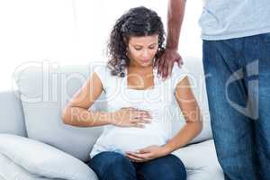 Man comforting pregnant woman