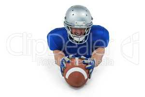 American football player reaching towards ball