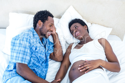 High angle view of husband and wife discussing on bed