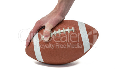 Close-up of American football player placing the ball