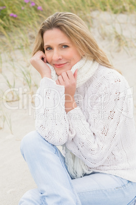 Woman sitting near the sandy hill