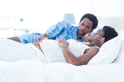 Man looking at pregnant woman while relaxing Man looking at pregnant woman while relaxing