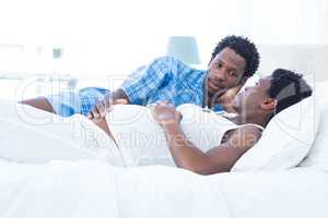 Man looking at pregnant woman while relaxing