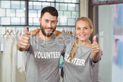 Portrait of smiling volunteers giving thumbs up