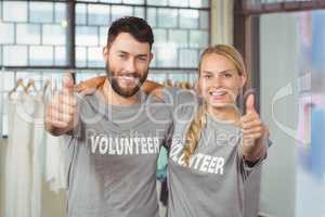 Portrait of smiling volunteers giving thumbs up