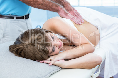 Masseur massaging pregnant woman