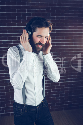 Hipster with eyes closed enjoying music