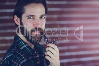 Portrait of smiling man with smoking pipe