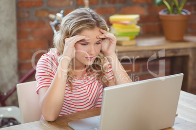 Stressed businesswoman working in creative office