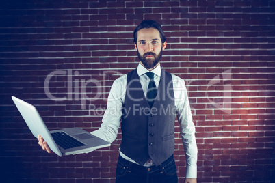 Portrait of confident man holding laptop