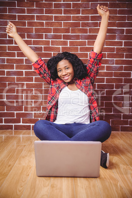 Hipster cheering and using laptop