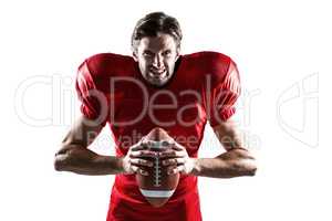 Aggressive American football player in red jersey holding ball