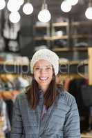 Smiling brunette with winter clothes looking at camera