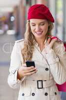 A happy smiling woman using her phone