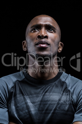 Thoughtful athlete against black background