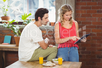 Businesswoman pointing towards digital table in office