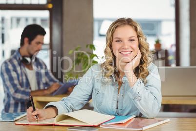 Portrait of happy beautiful woman in creative office