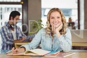 Portrait of happy beautiful woman in creative office