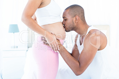 Man kissing his pregnant wife