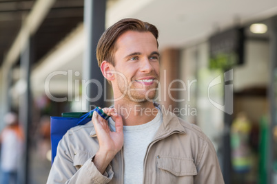 Portrait of a smiling man with shopping bags