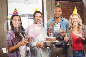 Portrait of casual business people celebrating birthday in offic