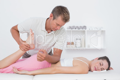 Physiotherapist doing leg massage to her patient