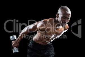 Muscular man bending while exercising